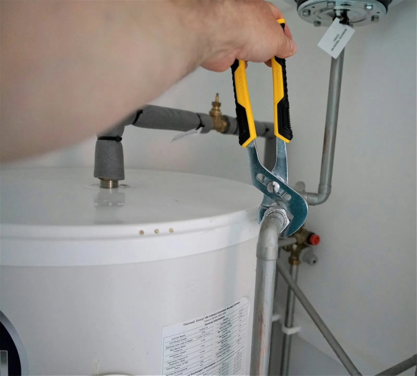 Impact technician installing a new water heater in a Monmouth County home